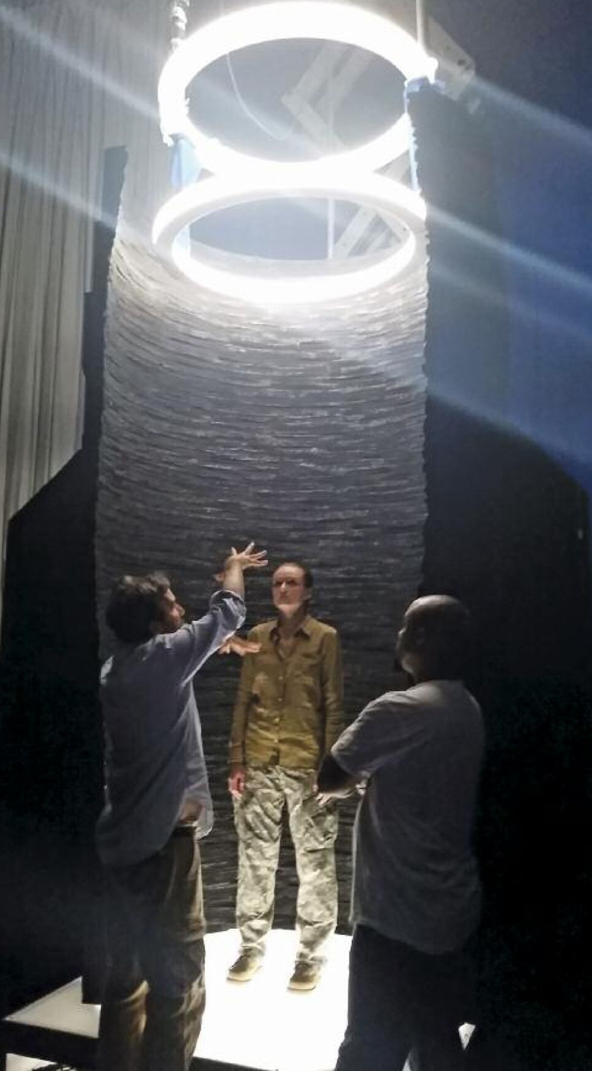 Young, director Denis Villeneuve and a stand-in work out a scene in which the aliens bring Banks aboard their vessel.